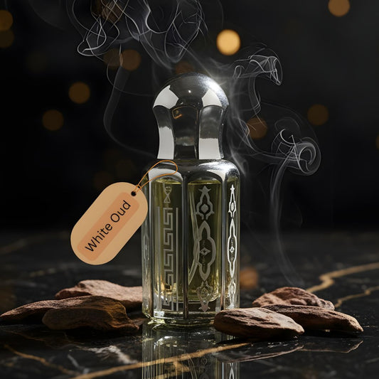 White Oud Purity by de Lalma Long lasting, luxury oud perfume bottle surrounded by aromatic smoke on a dark marble surface