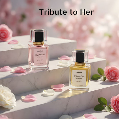 Tribute to Her, luxury and long-lasting perfume bundle by de Lalma, featuring two luxury fragrances: Royal Rebellion (Impression of Bright crystal by Versace) and Tommy Chic (Impression of Tommy Girl by Tomy Hellfiger), displayed on elegant marble steps surrounded by blooming roses and delicate flower petals.